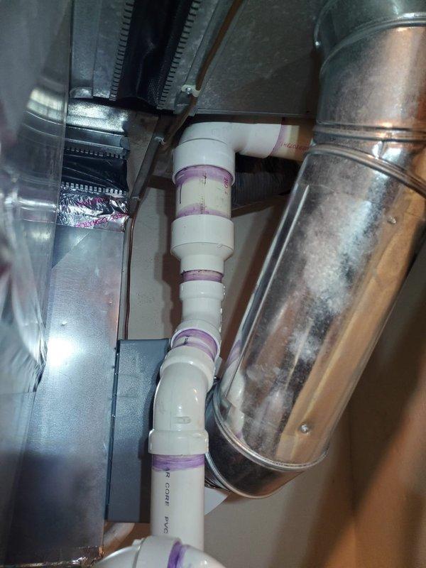 Repaired a condensation drain line leak on a three-year-old 90% furnace located in the basement. Inspection revealed PVC drain piping with proper purple primer at joints was intact but leaking at connection points; resealed all joints and confirmed proper drainage. System is now operating correctly with no moisture issues.