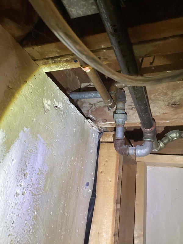 Performed diagnostic assessment on non-functional 2017 40-gallon water heater located in basement, confirming pilot light failure. Inspected existing plumbing infrastructure, noting moderate corrosion on pipe fittings and connections. Provided customer with tankless water heater replacement options to address current system failure.