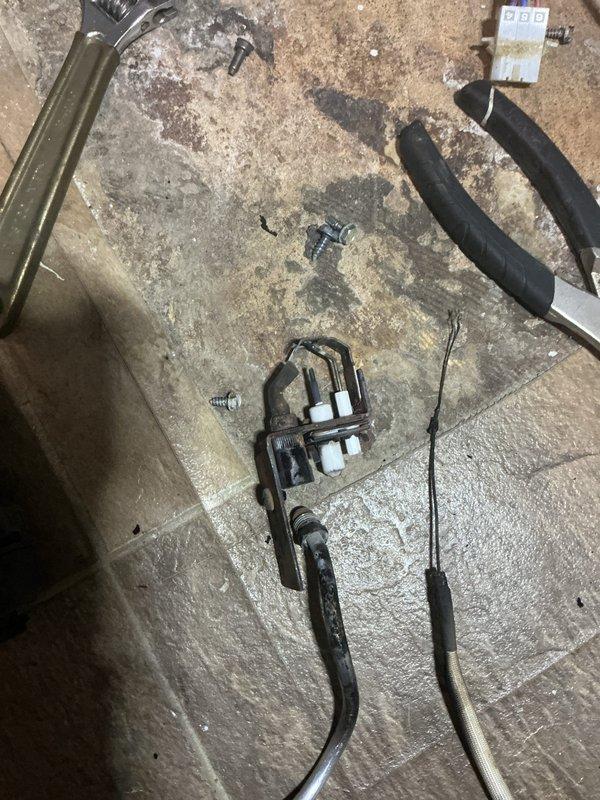 Diagnosed baseboard heating boiler failure resulting from recent storm damage. Removed and inspected electrical components, specifically focusing on the control assembly with wiring connections. Replaced damaged mounting bracket and reconnected all electrical terminals to restore proper boiler operation.