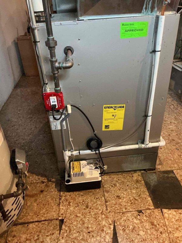 Responded to no-heat service call for an 11-year-old furnace in basement that would not turn on. Upon inspection of the aging unit with visible EnergyGuide label and "APPROVED" sticker, diagnosed and replaced faulty control module. System now operating properly with all connections verified and tested for proper heating function.