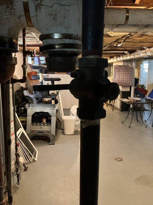 Responded to service call for leaking boiler of undetermined age (likely original to building) located in basement. Inspected system including pipe connections, valve assembly, and electrical components. Despite leak, unit continues to provide adequate heat; documented condition with photographs for future reference.