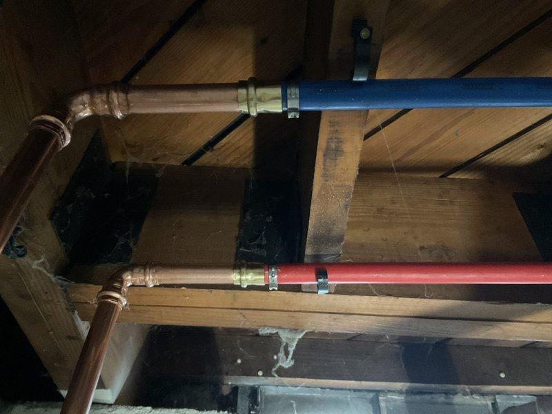 Successfully installed a 40-gallon tanked water heater with proper hot and cold water connections using PEX piping with copper fittings. Completed mechanical reconnection of the unit, including proper venting and secure mounting against the concrete block wall in the utility area.