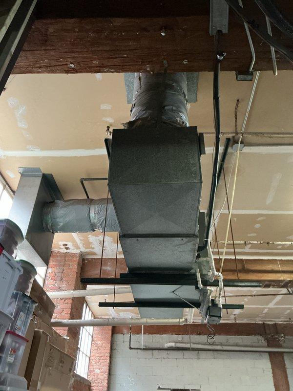 Performed diagnostic assessment on 29-year-old horizontal furnace located in garage, confirming heat exchanger failure as evidenced by tripping rollout switch. Unit is mounted near ceiling with extensive ductwork connections, including insulated round ducts. Prepared comprehensive replacement estimate for both furnace and potential AC replacement, with recommendation to address failing heat exchanger to restore heating functionality.