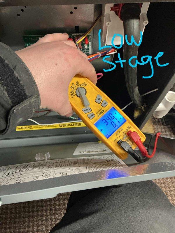 Responded to homeowner complaint of loud whining/electrical noises from 2-year-old Daikin furnace located in basement. Performed comprehensive diagnostic testing with multimeter, measuring voltage readings at low stage operation (340V). Inspected internal components including circuit boards and wiring harnesses to identify source of noise issue.