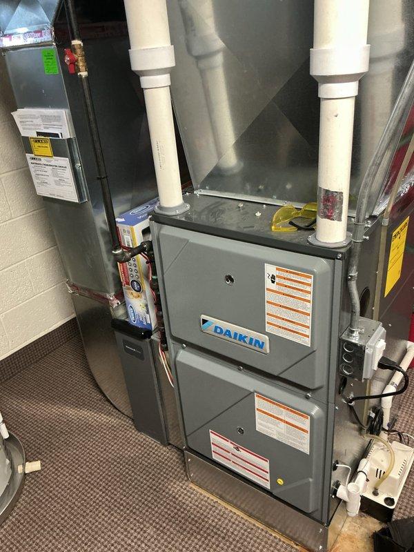 Responded to homeowner complaint of loud whining/electrical noises from 2-year-old Daikin furnace located in basement. Performed comprehensive diagnostic testing with multimeter, measuring voltage readings at low stage operation (340V). Inspected internal components including circuit boards and wiring harnesses to identify source of noise issue.