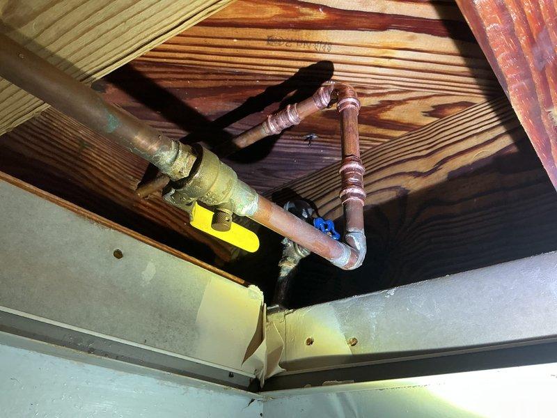 Responded to emergency call for active water leak in copper piping system. Upon inspection, discovered compromised 90-degree elbow joint in ceiling installation showing significant corrosion and mineral buildup. Replaced damaged fitting and section of affected copper pipe, pressure tested system to confirm repair integrity, and restored water service to residence.