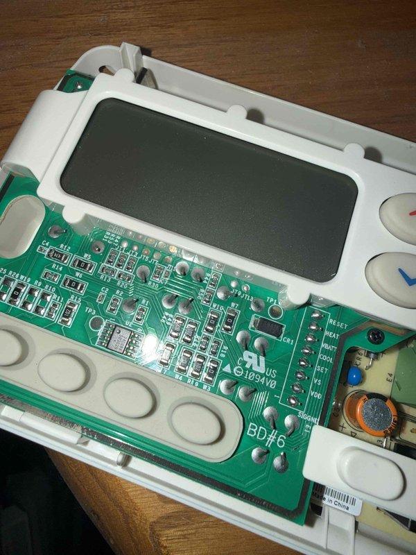 Diagnosed and repaired a malfunctioning Honeywell thermostat that was still allowing basic heating/cooling functionality. Opened unit to inspect internal circuit board (BD76), revealing corrosion on components. Replaced thermostat and verified proper system operation with the homeowner.