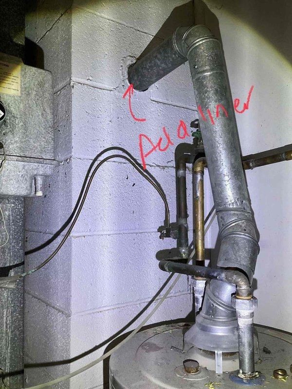 Conducted comprehensive site assessment for AC installation in a property with no existing cooling system. Inspected exterior utility connections including electrical service entrance and available mounting locations. Evaluated interior plumbing configuration with specific attention to the existing water heater vent system and identified potential AC condensate drain line connection point as marked on the utility room wall. Documented current infrastructure to determine optimal equipment placement and installation requirements for a complete HVAC system.