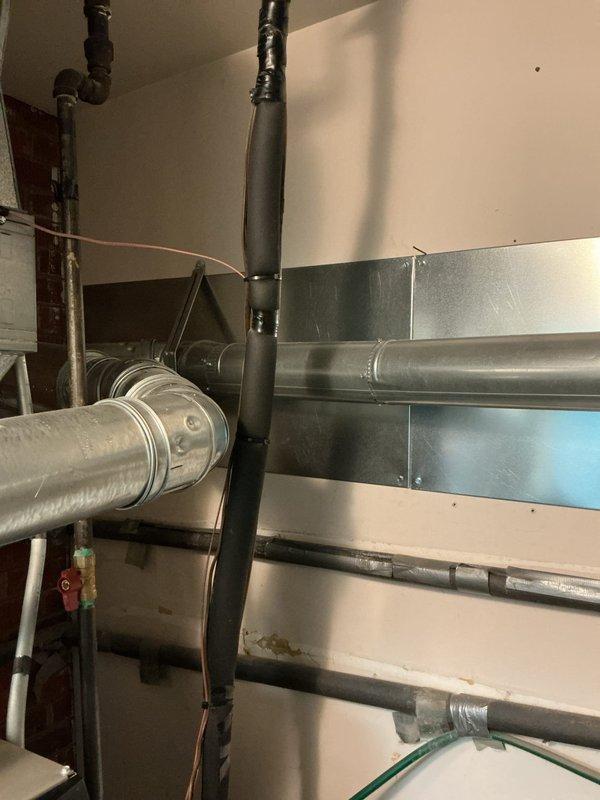 Identified and corrected mechanical violation 503.7.8 by ensuring proper 6" clearance between single wall vent pipe and combustible materials as required by table 503.10.5. Documented compliance with photographic evidence of the water heater installation and surrounding ductwork/piping configuration in the utility area.