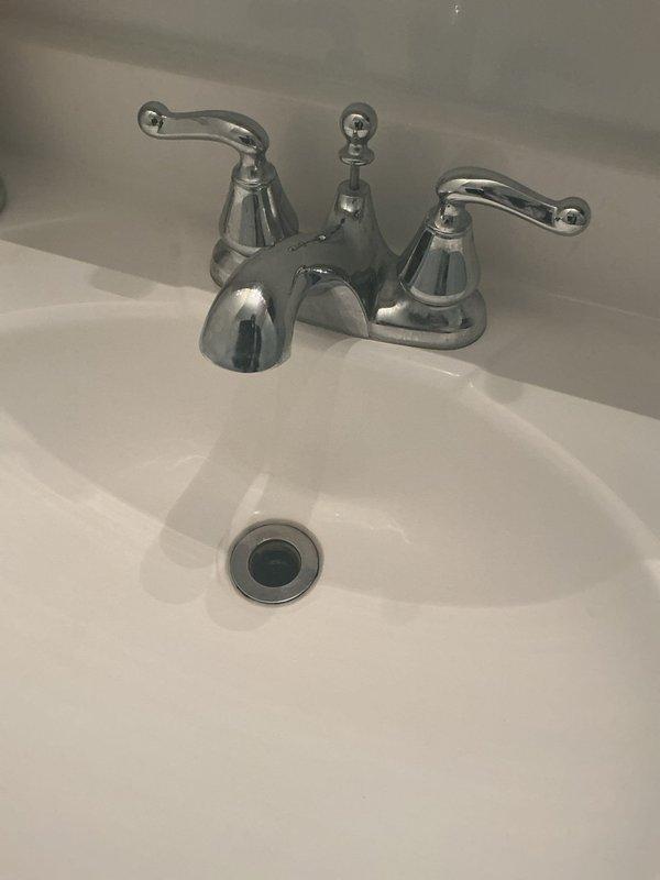 Repaired broken toilet handle (reference #59313-701-1545). Inspected tank components including float ball, flush valve assembly, and connecting mechanisms. Documented existing bathroom fixtures including sink and faucet installation for reference. All components now functioning properly.