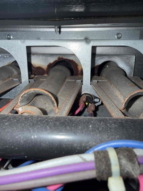 Responded to service call for non-operational furnace displaying error code L5. Inspection revealed severely rusted and corroded burners with significant oxidation damage, typical of an aging system (15 years). Visual inspection with diagnostic camera confirmed internal heat exchanger deterioration, indicating end-of-life condition requiring replacement recommendation.