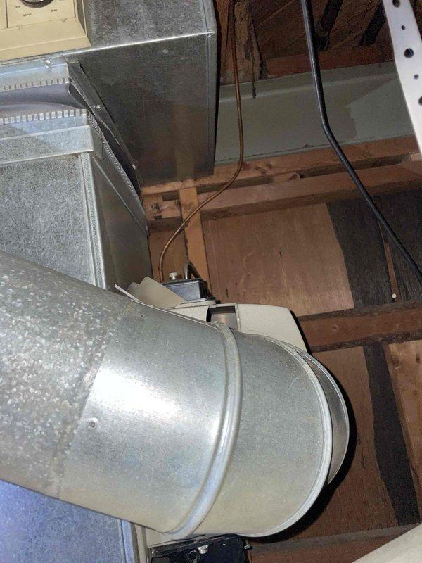 Conducted estimate for furnace replacement of 25-year-old unit located in basement for returning customer. Inspection revealed aging ductwork system with galvanized metal ducting connected to rectangular plenum in structural space. Noted existing plumbing and utility infrastructure including copper supply lines and electrical wiring that will need to be considered during replacement.