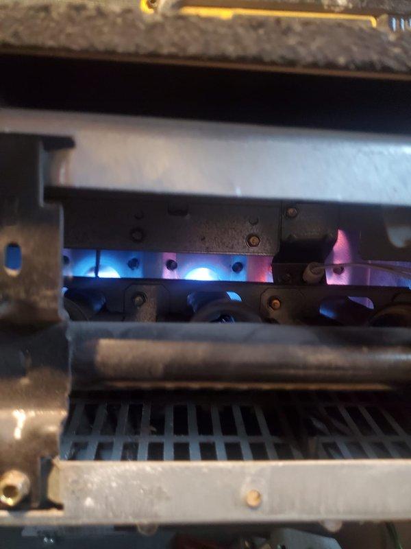 Completed Gold Furnace Inspection on forced air system located in basement. Inspected burner assembly, confirming proper flame pattern with characteristic blue flames indicating complete combustion. Identified minor rust formation at exhaust connection point requiring monitoring, but system is currently operating within normal parameters.