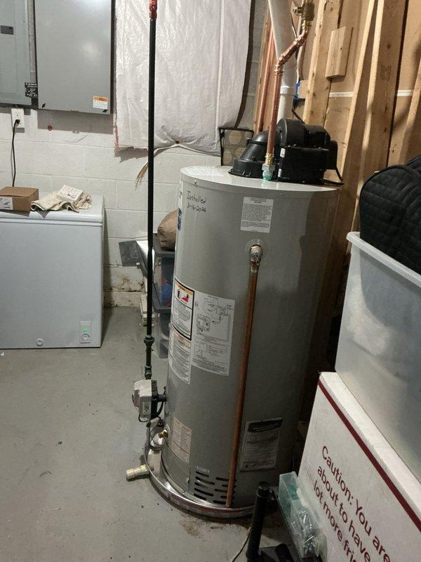Installed new 50-gallon power vent water heater in basement utility room with required drip pan featuring alarm system. Connected unit to existing copper plumbing lines and verified proper operation. Installation included all necessary safety features and compliance with current plumbing codes.