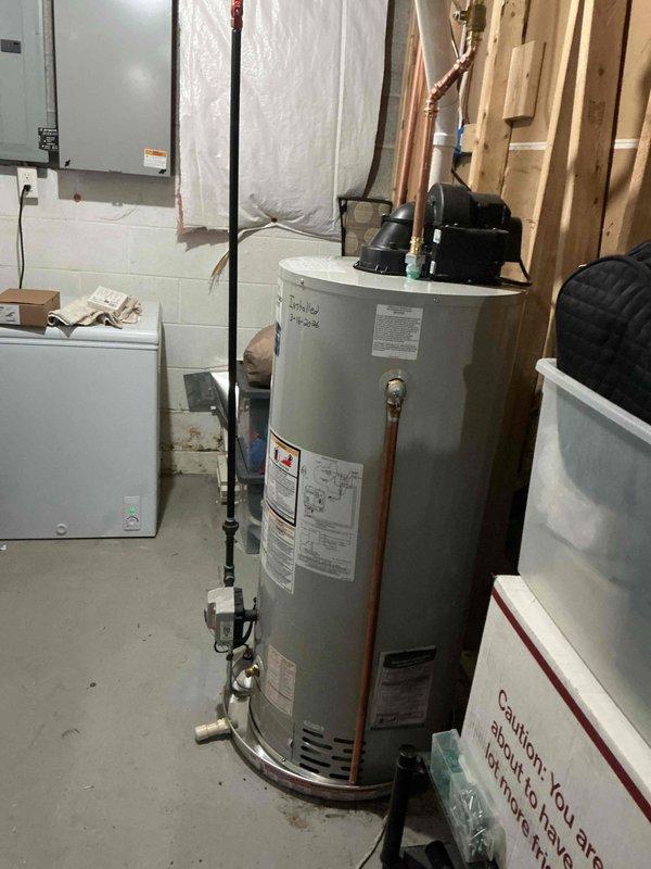 Installed new 50-gallon power vent water heater in basement utility room with required drip pan featuring alarm system. Connected unit to existing copper plumbing lines and verified proper operation. Installation included all necessary safety features and compliance with current plumbing codes.