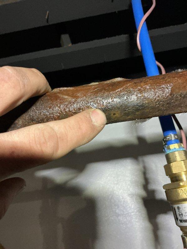 Responded to service call for a 3-month-old boiler exhibiting excessive steam and leakage from pipe onto basement floor. Inspection revealed severe corrosion on copper piping and deteriorated pipe insulation. Replaced damaged section of copper pipe and installed new insulation to resolve the leakage issue and prevent further water damage.