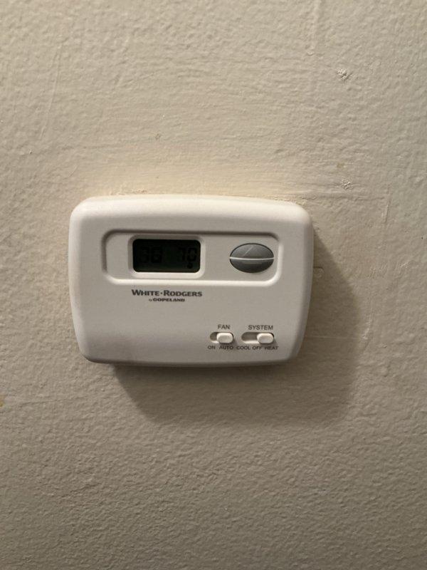 Conducted assessment for replacement of 50-year-old furnace located in basement. Inspected existing White-Rodgers thermostat and examined current HVAC infrastructure including insulated piping and ductwork. Documented condition of aging system to prepare comprehensive replacement estimate.