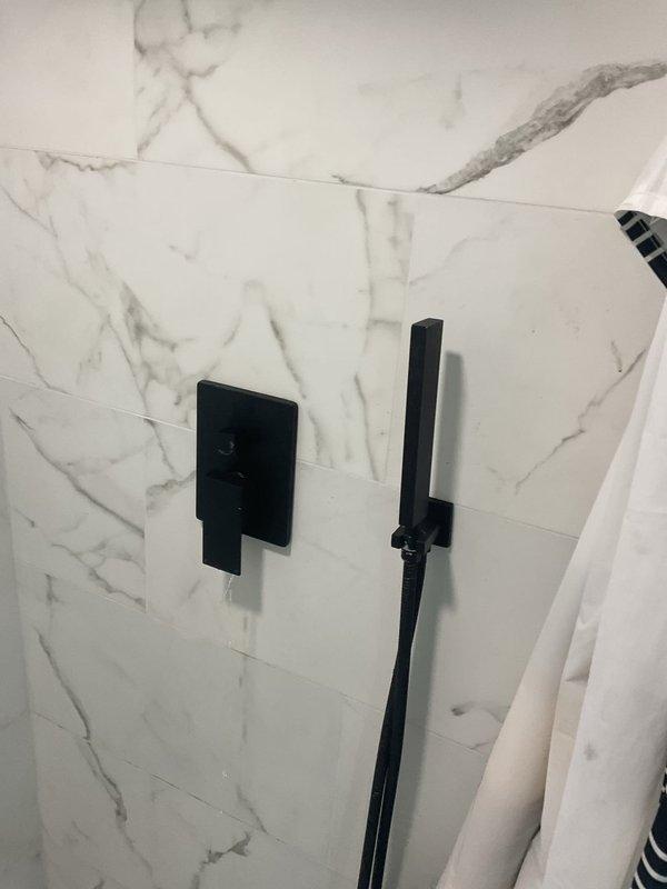 Diagnosed and repaired water leak from shower control handle in basement bathroom, which was causing issues with both hot and cold water flow regulation. Replaced faulty valve assembly and verified proper operation of new components with no further leakage observed during testing.