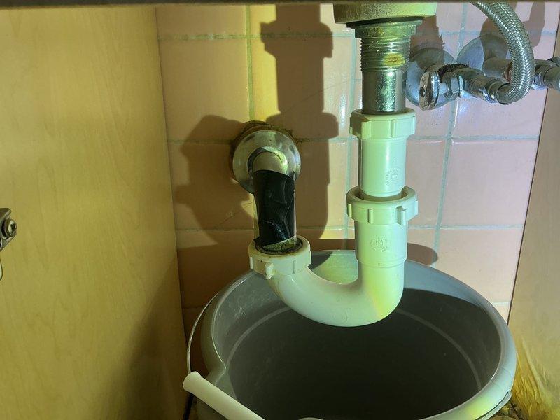 Conducted inspection of water leak originating from shower/bath fixture that was causing damage to kitchen ceiling below. Documented significant ceiling damage with visible corrosion on exposed pipes and water staining. Provided estimate for complete replacement of bathroom fixtures including showerhead, faucet, and spout to resolve the ongoing leak issue.