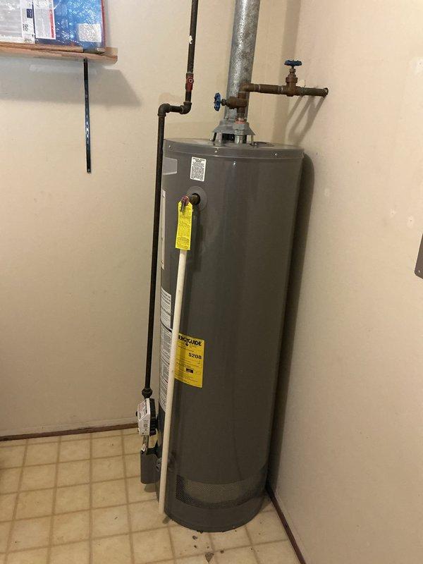 Responded to service call for water tank leak in laundry room. Upon inspection, replaced faulty water heater with new unit, installed proper ventilation pipe to ceiling, and connected all required copper piping with appropriate shut-off valves. System was tested and confirmed to be functioning correctly with no leaks present.