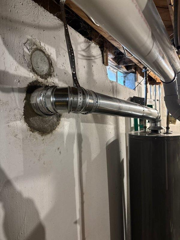 Successfully completed the deferred A/C installation, including proper connection of refrigerant lines, electrical wiring, and installation of the chimney liner. Installed and secured metal ductwork with appropriate elbow joints through the foundation wall, ensuring proper sealing at penetration points. System is now operational with all connections properly insulated and secured.