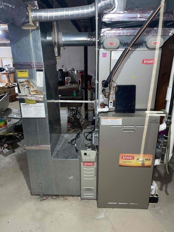 Performed assessment of 20+ year old Bryant Plus 90i furnace with failed inducer motor located in basement. Evaluated existing HVAC setup including ductwork configuration and ventilation system with PVC exhaust piping. Provided replacement options for the aging furnace system, noting proper specifications would be required for the basement installation with consideration for the existing condensate pump and drainage configuration.