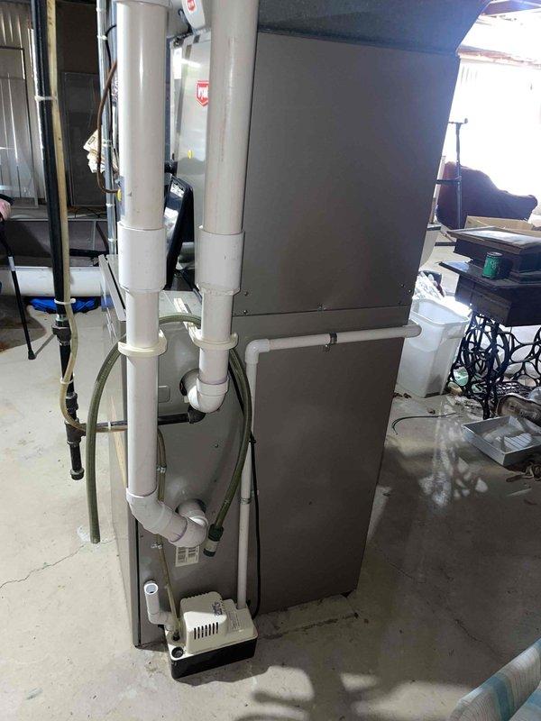 Performed assessment of 20+ year old Bryant Plus 90i furnace with failed inducer motor located in basement. Evaluated existing HVAC setup including ductwork configuration and ventilation system with PVC exhaust piping. Provided replacement options for the aging furnace system, noting proper specifications would be required for the basement installation with consideration for the existing condensate pump and drainage configuration.