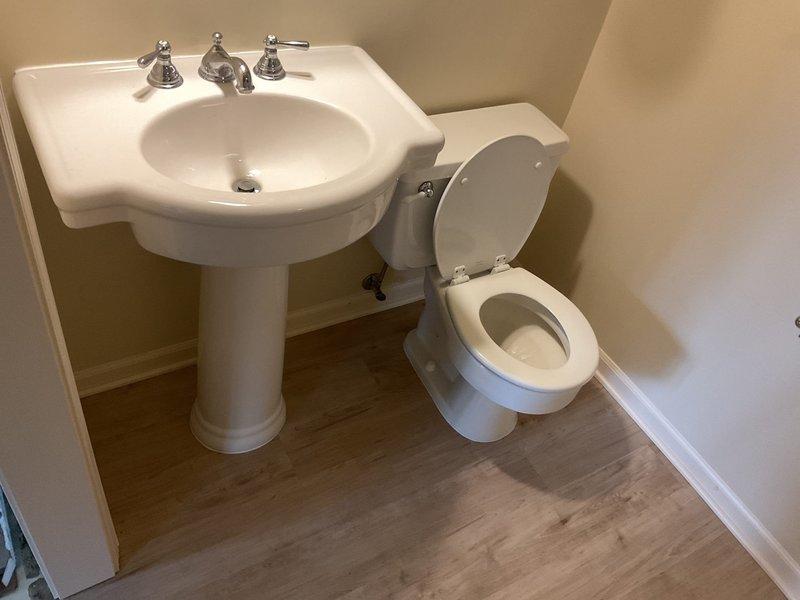 Successfully reinstalled pedestal sink and toilet following customer's new floor installation. Connected all plumbing fixtures, including proper P-trap assembly under sink, and verified all connections for leaks. Both fixtures are now securely mounted and fully operational.
