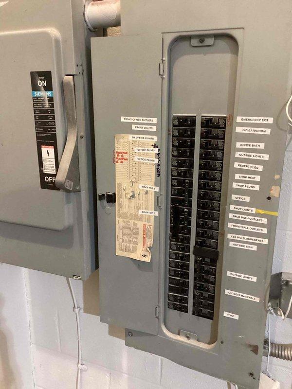 Performed site assessment for RTU replacement estimate on a 2001 Lennox unit with failed heat exchanger. Documented existing electrical panel configuration and commercial workspace layout with photos. Confirmed roof access requirements for future installation work.