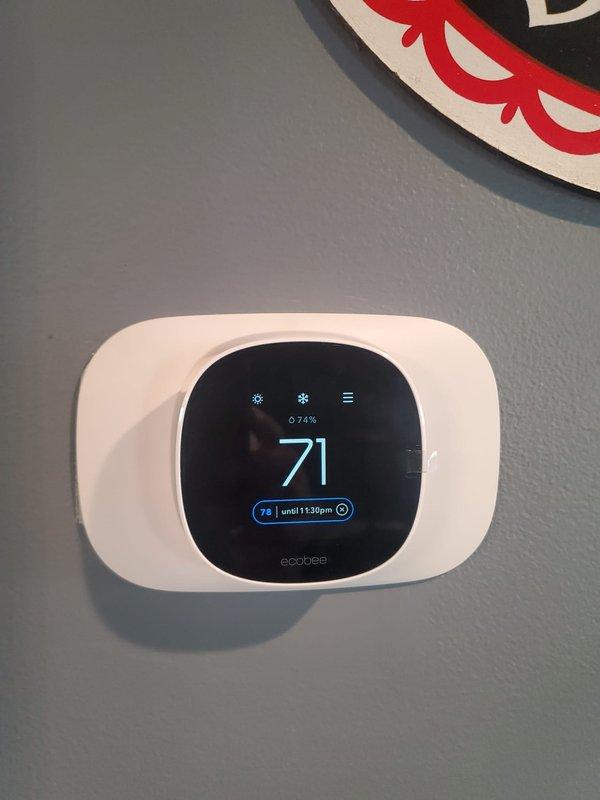 Successfully installed new Ecobee thermostat to replace existing 6-year-old unit that was malfunctioning (displaying errors and failing to shut off properly). System is now functioning correctly with thermostat showing proper temperature control settings and successfully regulating the HVAC system.