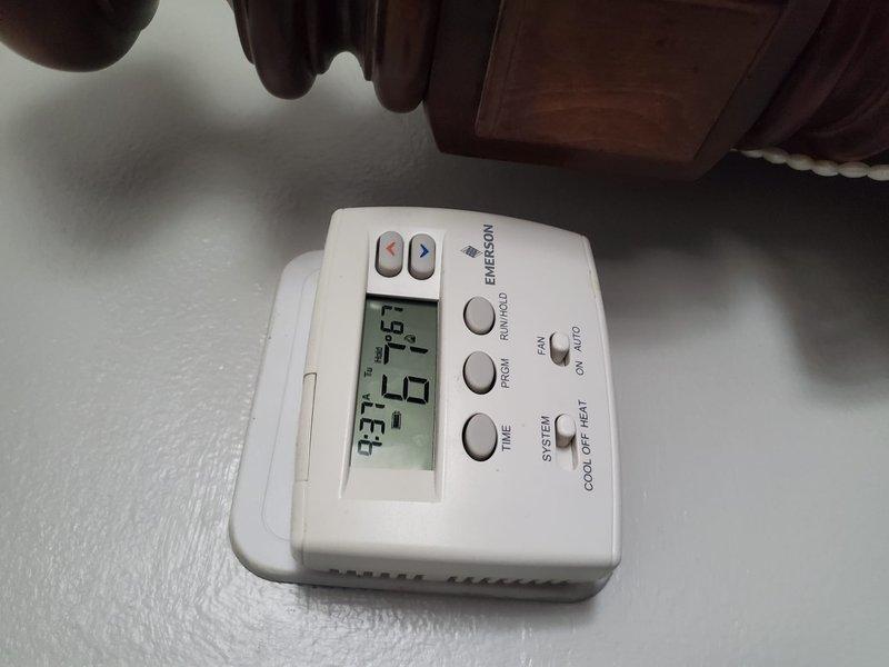 Performed Gold Furnace Inspection on a 10-year-old residential unit located in basement. Visual inspection confirmed proper thermostat operation (Emerson model showing 73° current/67° set point) and examined heat exchanger components with blue flame indication suggesting proper combustion. System was operational with no immediate concerns identified.