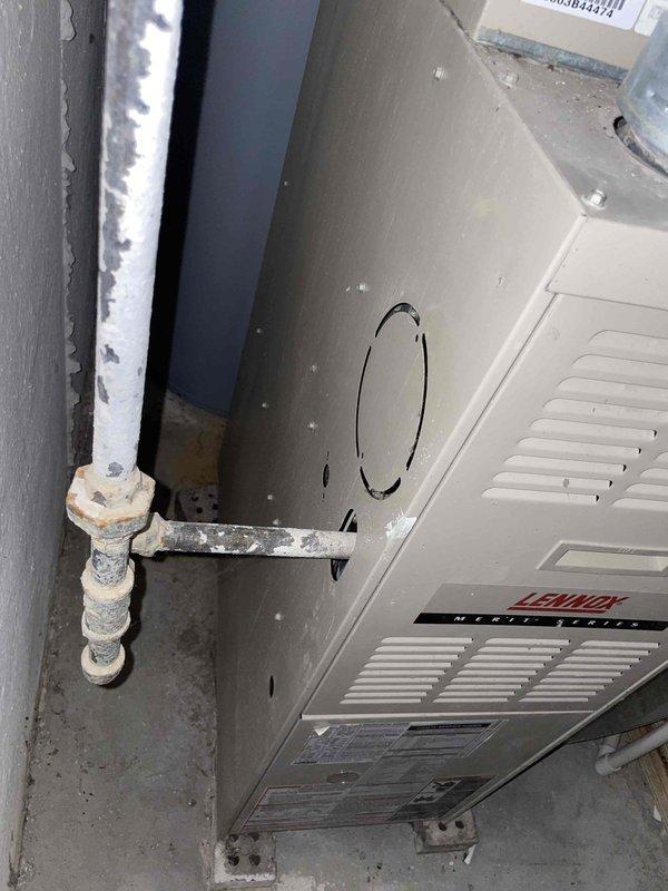 Conducted assessment of 26-year-old non-operational furnace in basement requiring replacement. Inspection revealed aging Lennox unit with significant wear on connection points and visible corrosion on pipe fittings. Recommended full system replacement due to equipment age and condition.