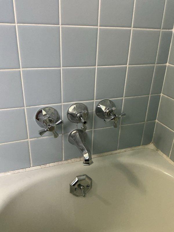 Responded to service call for non-functional shower faucet in main bathroom of 70-year-old home. Created access panel to inspect plumbing, identified corroded brass/copper pipes and T-joint connections causing the malfunction. Replaced deteriorated plumbing components and restored proper water flow to the shower/tub fixture.