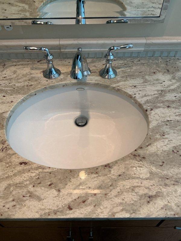 Successfully installed new customer-supplied lavatory faucet in bathroom. Properly connected hot and cold water supply lines with braided stainless steel connectors to existing copper pipes and secured PVC P-trap drain assembly. All connections tested with no leaks detected and proper water flow confirmed.