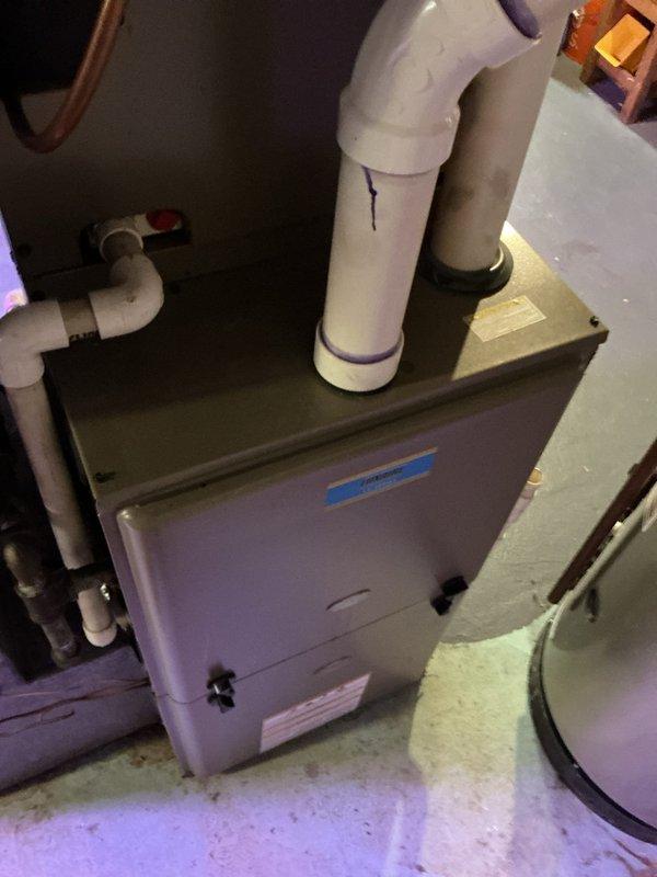 Responded to no-heat call for Lexair furnace less than 10 years old located in basement. Diagnostic testing with multimeter revealed negative voltage readings (-2.9V) at control board. Inspected venting system and identified minor condensate leak at PVC pipe joint, which was sealed to prevent further moisture damage. Replaced faulty control board to restore proper furnace operation and verified system functionality before completing service.