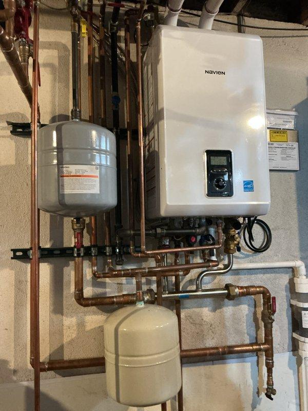 Performed preventative maintenance on Navien tankless water heater system, including comprehensive system flush to remove mineral buildup and replacement of condensate neutralizer to prevent acidic discharge damage. Inspected all copper piping connections, expansion tank, and pressure components, confirming proper operation of the complete installation with no leaks or pressure issues detected.