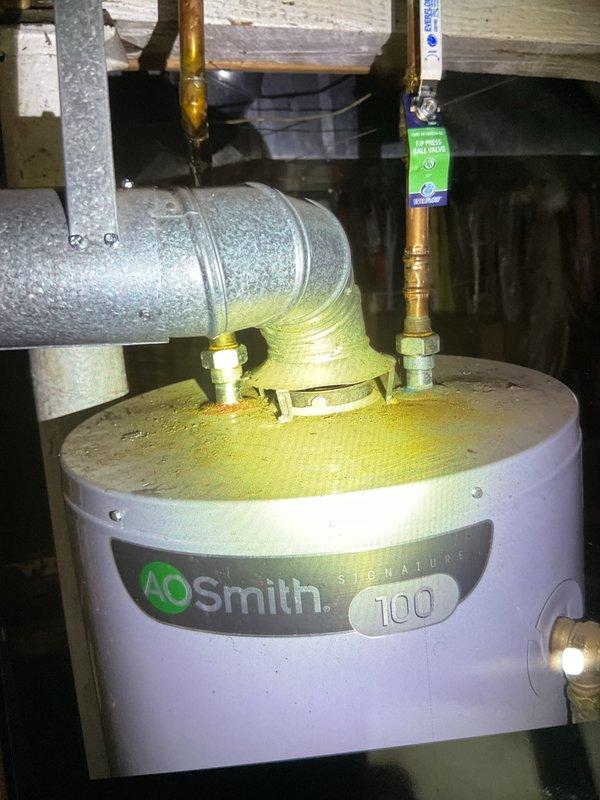 Completed Gold Furnace Inspection on a 4-year-old unit located in basement. Inspected air filter condition, noting proper installation of diamond-patterned mesh filter. Observed A.O. Smith Signature 100 water heater with minor mineral deposits at connection points; all copper pipes and venting appeared to be functioning normally.