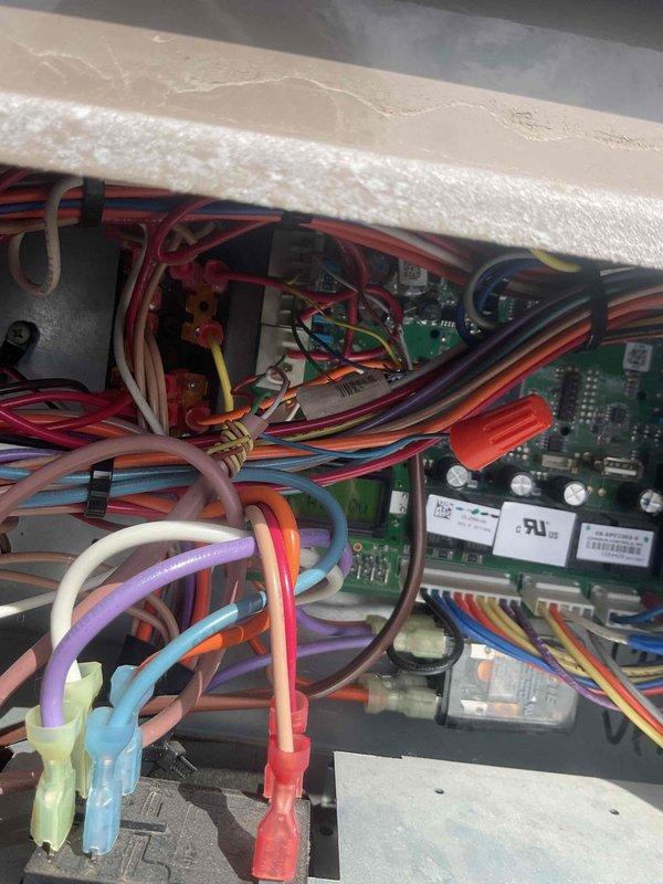 Responded to service call for a rooftop RTU experiencing intermittent operation requiring manual resets at the breaker. Inspection revealed communication issues between the control board and main system components, with visible wire connection problems identified in the control panel. Repaired damaged wiring connections, secured loose terminal connectors on the circuit board, and verified proper communication between all system components. Unit now operating correctly with stable performance.
