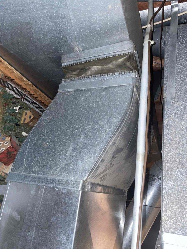 Conducted comprehensive evaluation of a 2004 Carrier furnace with failed inducer motor. Inspected existing ductwork system, noting significant wear on galvanized components and condensation staining on vertical surfaces. Provided replacement estimate for the aging system which had stopped heating after customer's unsuccessful attempts to address ignition sensor issues.