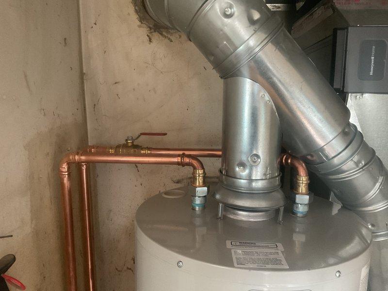 Successfully installed a 40-gallon tall water heater in a confined utility space. Properly connected copper supply lines with brass fittings and installed galvanized steel vent piping with secure joints. Verified all connections were leak-free and system was functioning correctly before completing the installation.