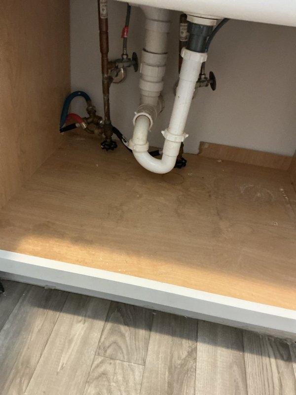 Responded to service call for drainage backup issue where washing machine discharge was causing backup through multiple fixtures extending to kitchen sink. Inspection revealed interconnected drain system with potential blockage in main line. Performed drain clearing service on the affected plumbing system, focusing on the utility sink connection and under-sink P-trap assembly. Successfully restored proper drainage function throughout the system.