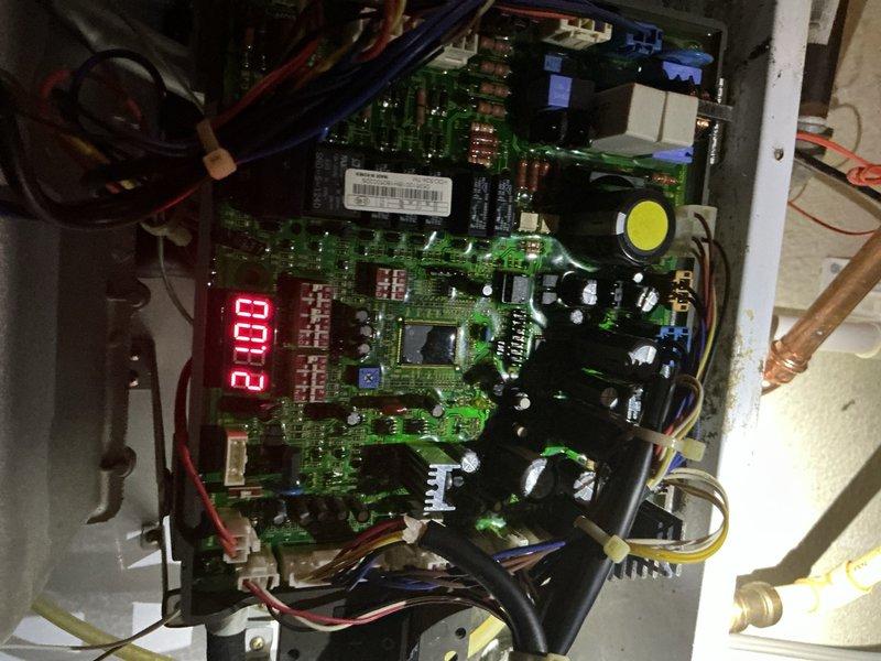 Responded to service call for non-operational tankless water heater related to previous repair. Inspected system components including gas line, temperature control unit (displaying 68°), and electronic control board (showing 208 on display). Diagnosed issue with circuit board connections and repaired faulty wiring to restore proper functionality of the tankless unit.
