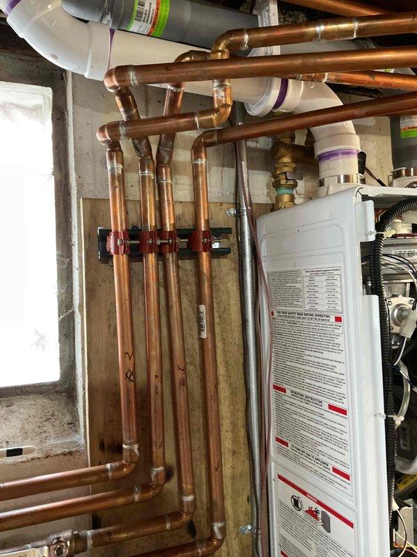 Diagnosed issue with upstairs heating system in a residential property. Inspection of the basement utility room revealed proper functioning of the copper piping system with no visible leaks or damage. Determined the problem was a faulty zone valve preventing proper flow to the upstairs heating zone. Replaced zone valve, bled the system, and confirmed proper heat distribution to all zones.