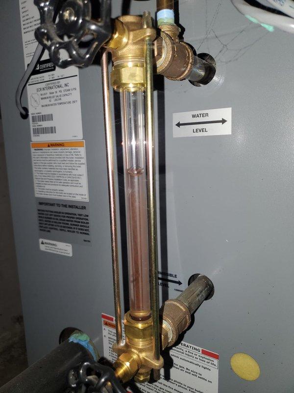 Performed routine inspection of 2-year-old boiler system. Verified proper water level in sight glass indicator and checked all brass valves and fittings for integrity. Examined exhaust ventilation, PVC connections, and copper piping throughout the system with no issues identified. System is functioning properly and within normal operational parameters.