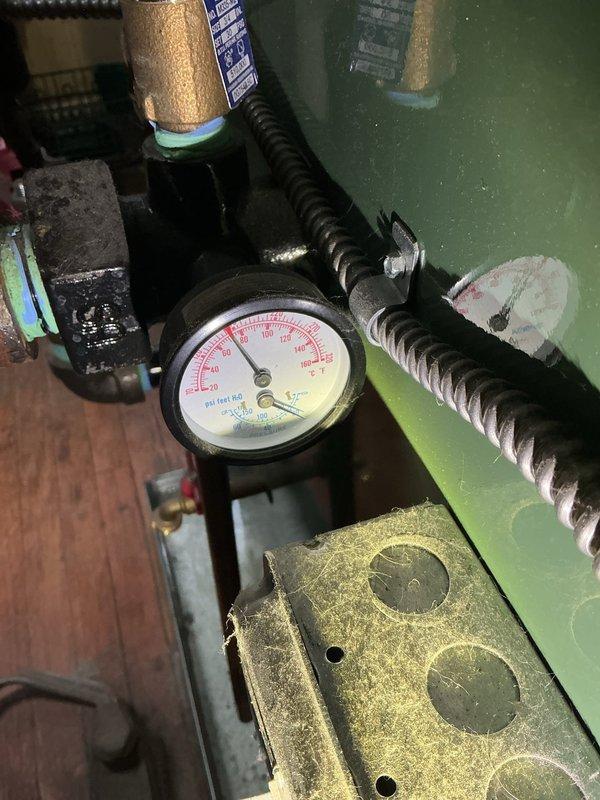 Responded to a callback for a 12-year-old boiler system with reported water leakage and insufficient heating. Customer reported temperature drop from set point of 72°F to 62°F overnight. Diagnostic inspection revealed low system pressure as indicated on pressure gauge. Restored proper pressure, verified burner operation, and confirmed system was heating correctly before completing service.