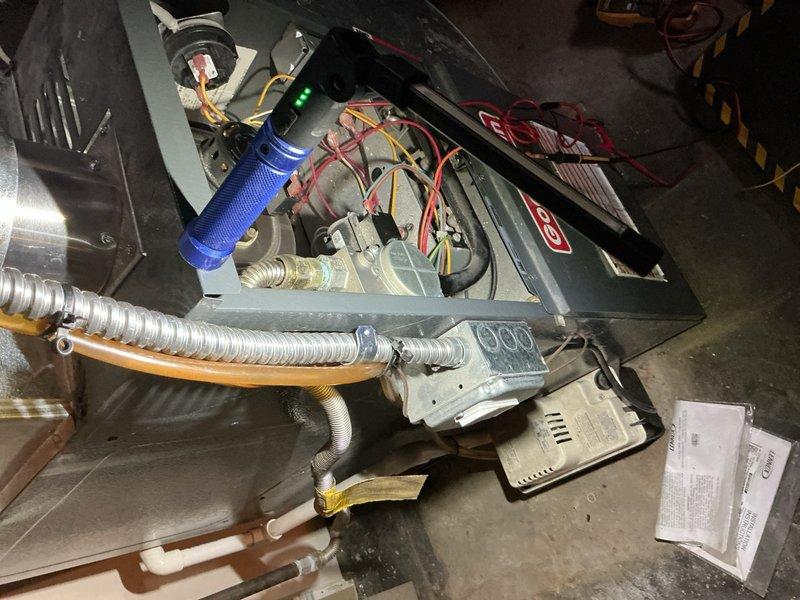 Responded to no heat complaint in a residential furnace system located in basement. Upon inspection, found flame sensor contaminated with carbon buildup causing intermittent flame failure and system shutdown. Cleaned flame sensor with emery cloth, verified proper ignition sequence, and confirmed system operation with multiple heating cycles. Unit now functioning properly with consistent flame detection and appropriate heat output.