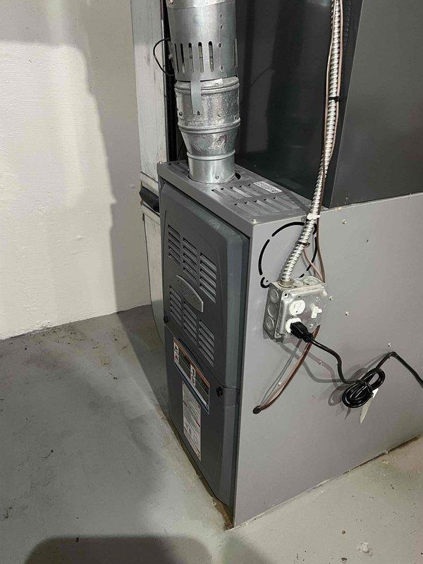 Performed comprehensive tune-up on 15-year-old furnace located in basement, including thorough cleaning and full system inspection. Examined flue pipe connections and verified proper exhaust ventilation system functionality. Checked gas line connections and electrical components for safety compliance, with all systems now operating within manufacturer specifications.