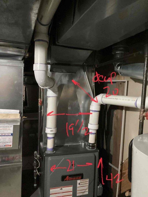 Conducted an estimate for replacement of an existing gas furnace located in the basement. Current Amana unit is operational but age is unknown. Inspected and documented the existing PVC vent pipe configurations (2" diameter) with multiple turns and connections, and measured critical dimensions (19½" and 14") for proper replacement sizing. Evaluated ceiling clearance and existing ductwork to ensure compatibility with potential replacement systems.