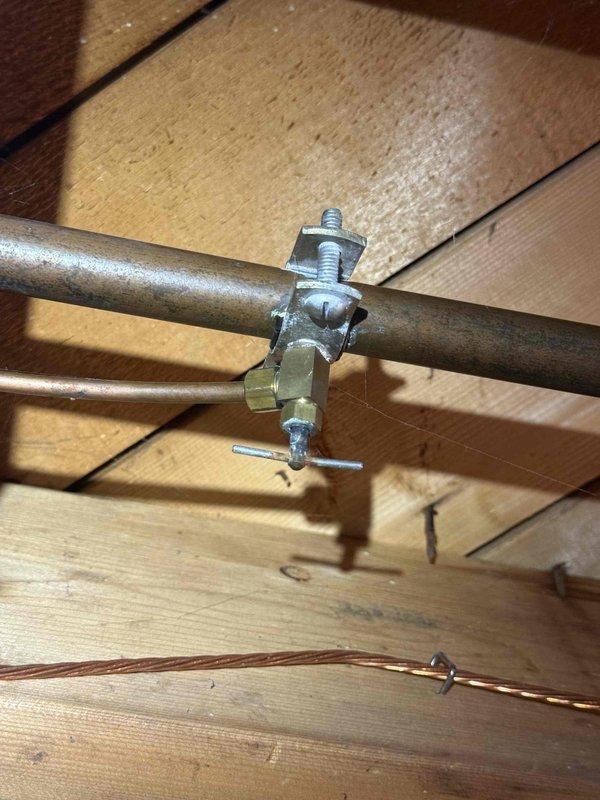 Responded to water leak complaint for 20-year-old furnace located in basement. Diagnosed issue as condensate drainage problem with significant mineral buildup in utility sink drain. Repaired leaking connection at copper pipe junction by replacing clamp fitting and securing all plumbing components to prevent future leakage.