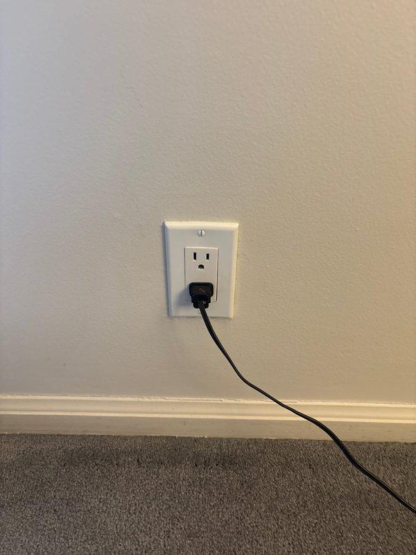 Responded to service call regarding a loose outlet plate in first floor bedroom. Upon inspection, found the electrical outlet was partially detached from the junction box due to aggressive unplugging. Secured the outlet properly in the wall junction box and verified proper function by testing with customer's existing plugged device.